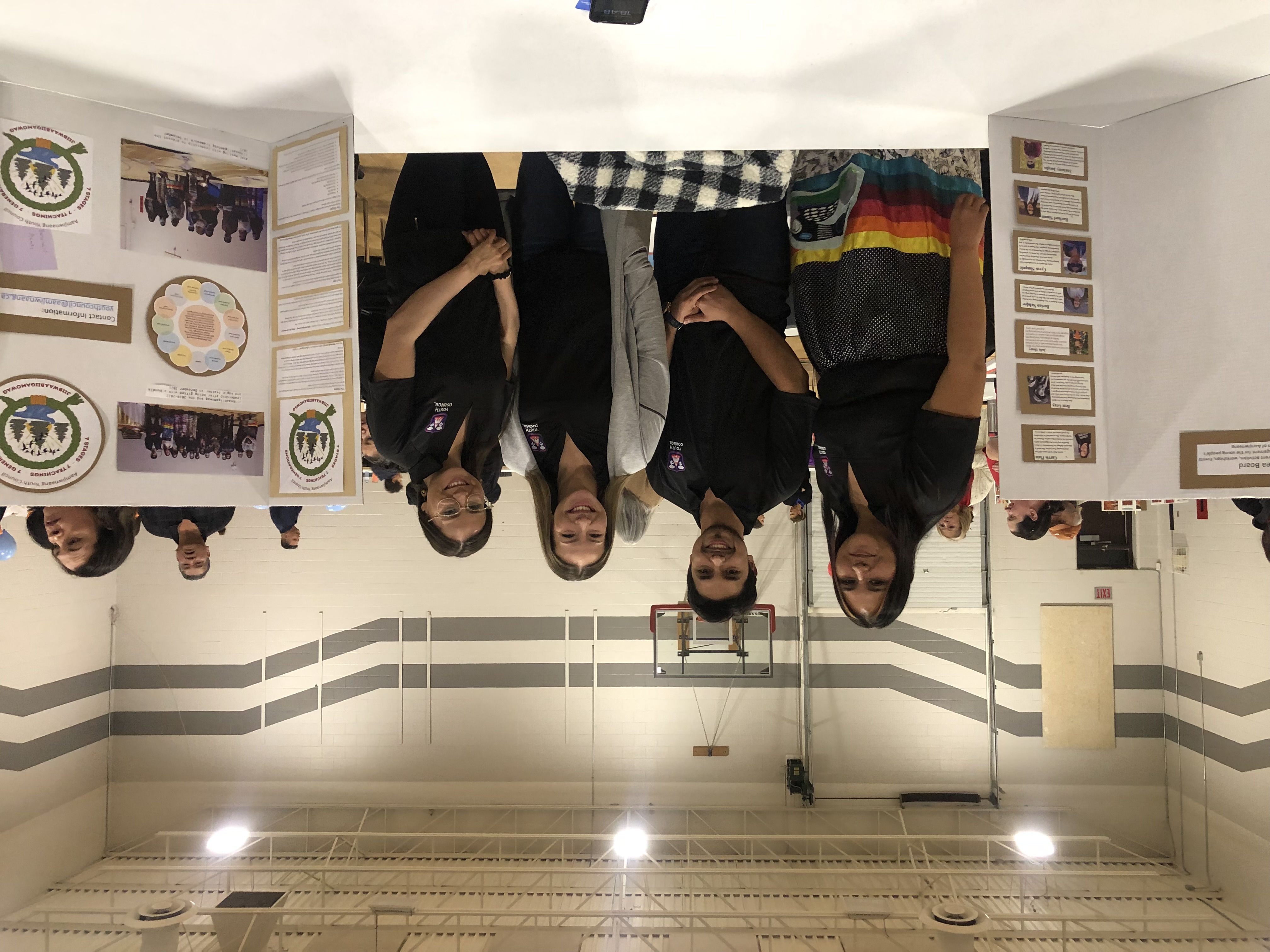 Anthony Huete-Jacobs with Aamjiwnaang Youth Council members at an information booth